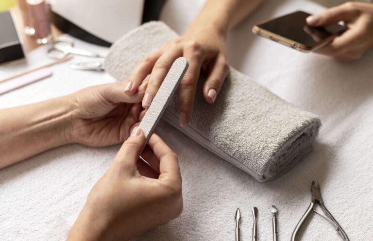 close up manicurist holding nail file min scaled 1 1